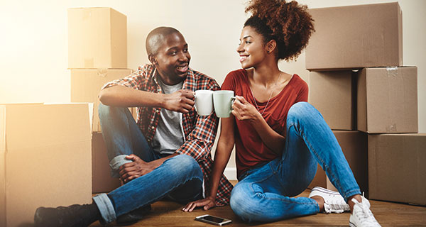 A man and a woman cheers over coffee in their new home. A man and a woman cheers over coffee in their new home.